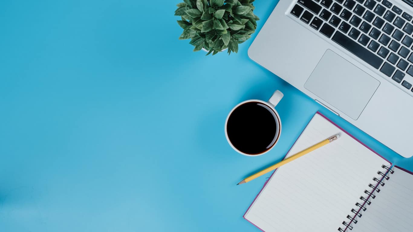 laptop and coffee on blue table